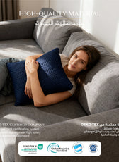 Woman lying on a gray sofa with a blue cushion