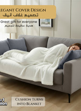 Woman lying on a gray sofa with a white blanket