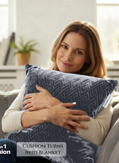 Woman holding a 2-in-1 cushion that turns into a blanket, sitting on a couch